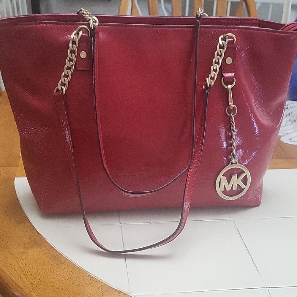 Michael Kors Glossy Red Tote with Gold Accent " Like New" Price Is firm.